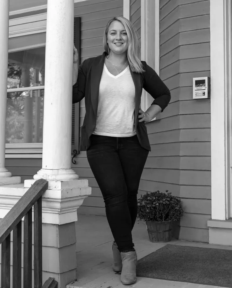 Woman sitting around a desk with laptops