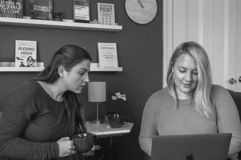 Two women at a computer looking at a business plan